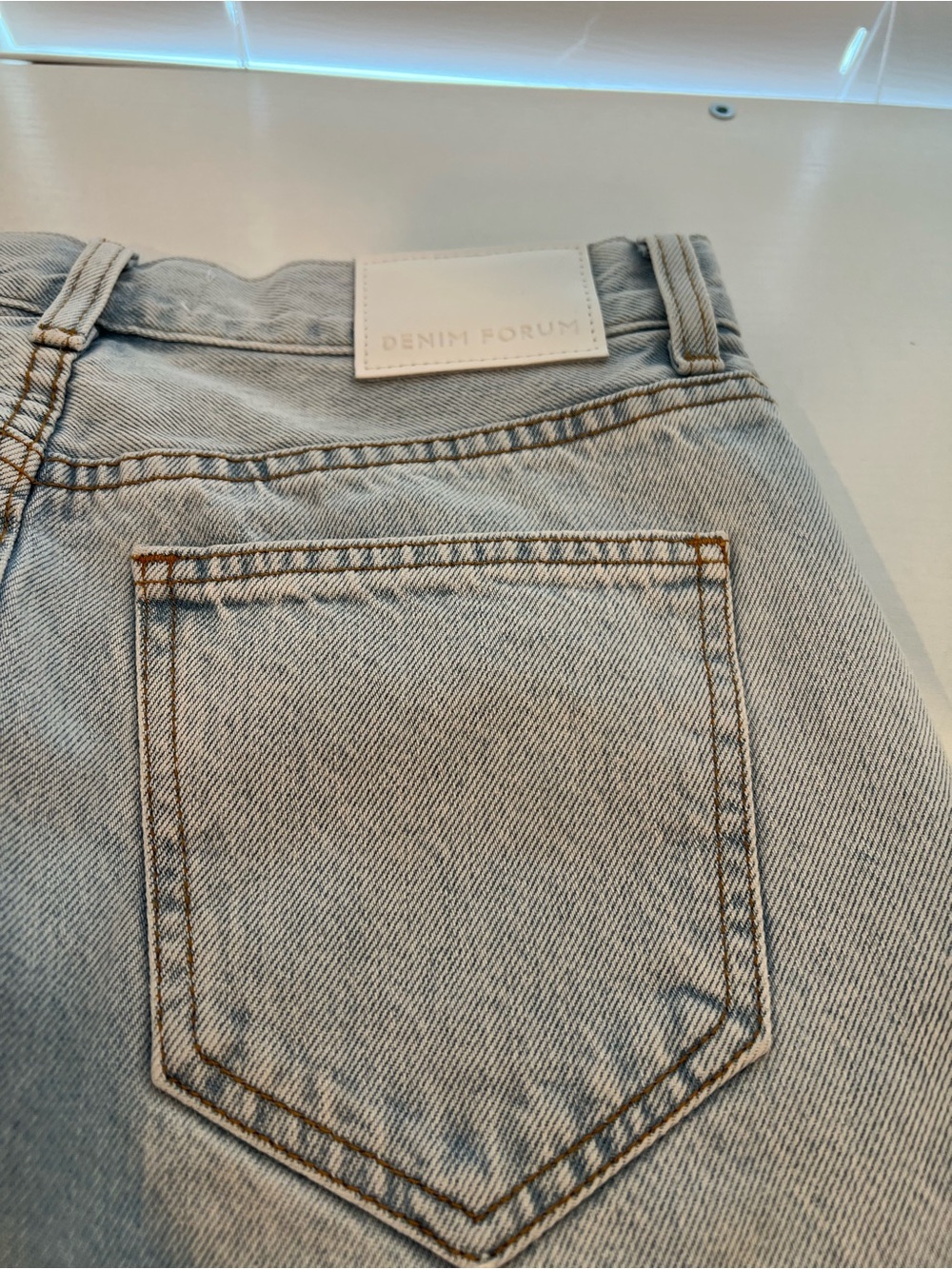 Aritzia Light Blue High-Rise denim skirt  with Tan Topstitching. HAS SLITS